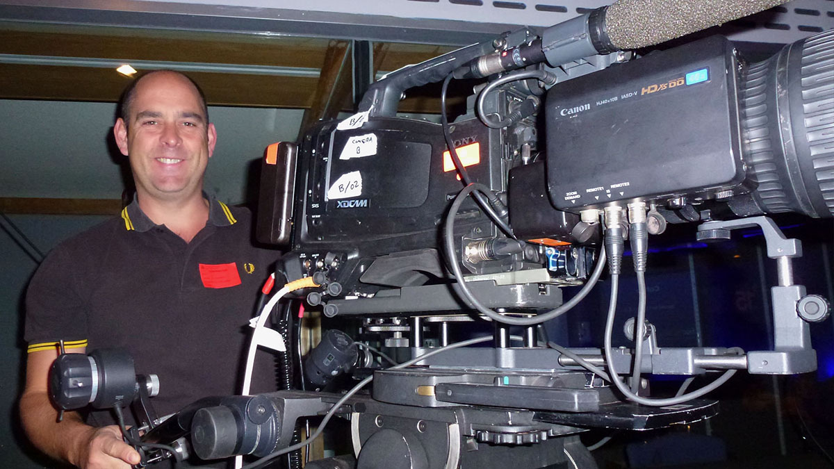 Cameraman Adam Stidwell at the QEII Conference Centre filming speaker close up for Fortius Clinic Fisic 15 live event with Sony XDCAM fitted with Canon HJ40x10B super telephoto lens, superb for long distance live events and sport. Impressive 10 x 400mm focal length. Multi-camera live event filming.