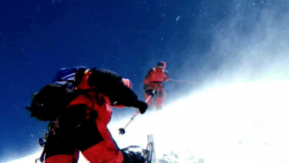 Army on Everest video garage image, a soldier and high altitude cameramen filmed climbing a steep treacherous snow and ice mountain landscape, a cold, windy and dangerous environment